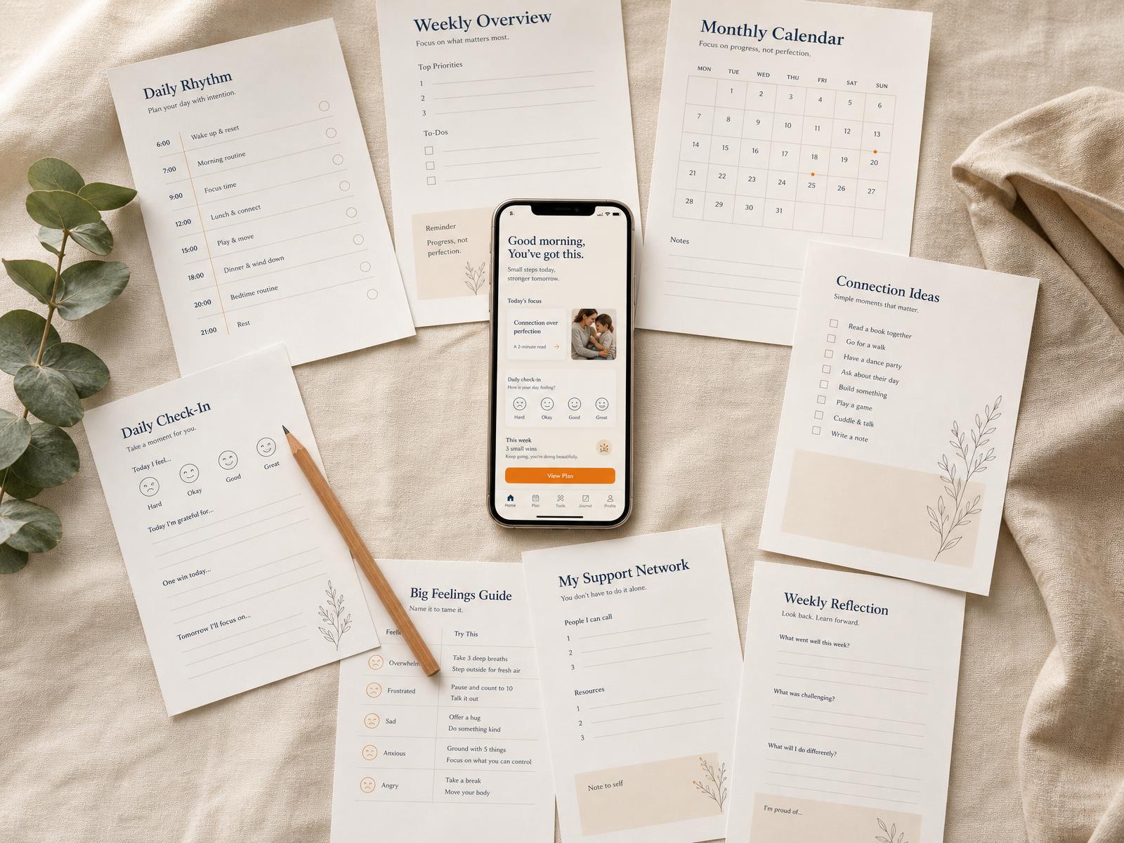 Parent Decoder on a phone surrounded by printed worksheets, a pencil and eucalyptus on warm cream linen